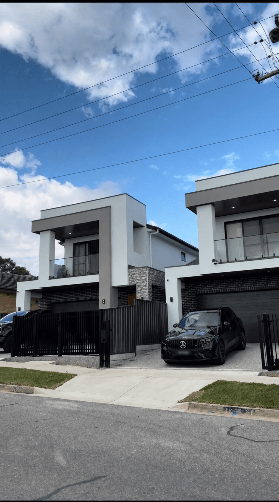 Modern double-storey homes with balconies and dark garage doors